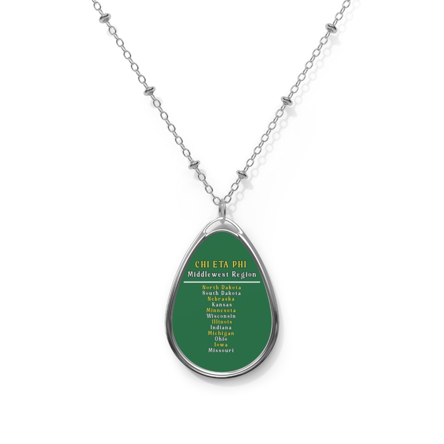 Teardrop-shaped pendant with green background and text on a white background